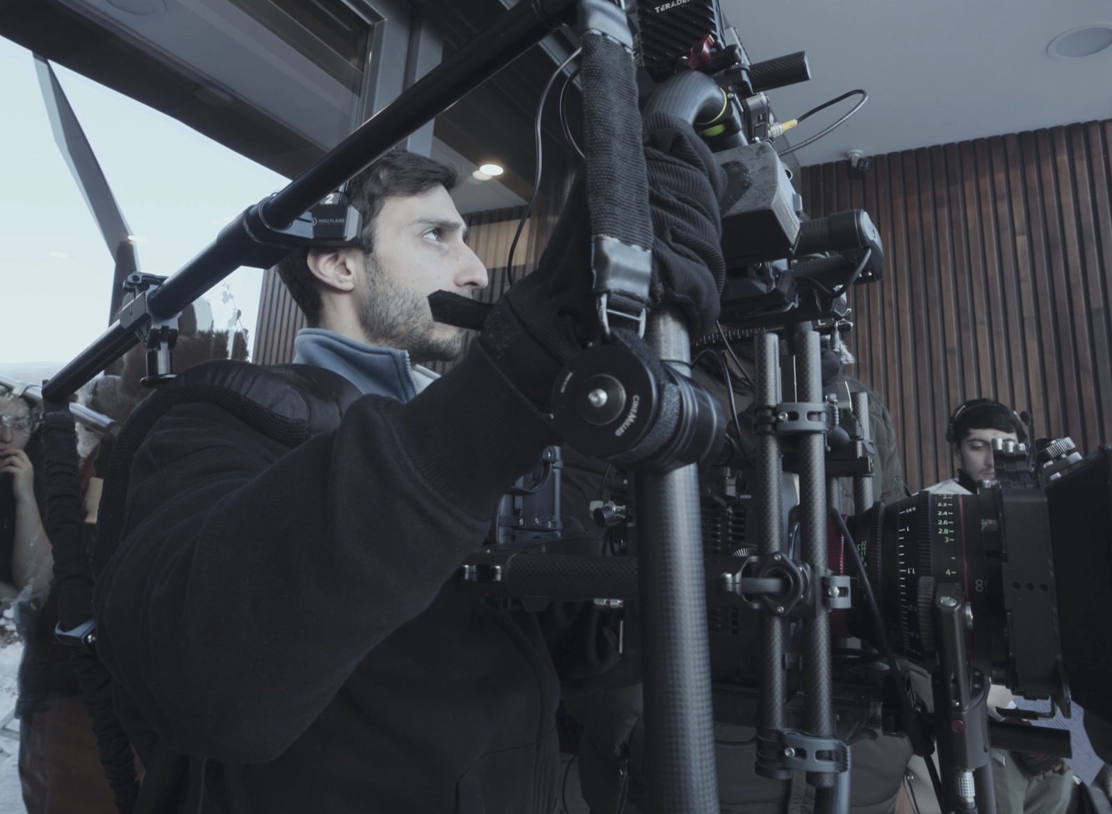 Camera operator on a stabilizer rig with a Canon cinema camera on location