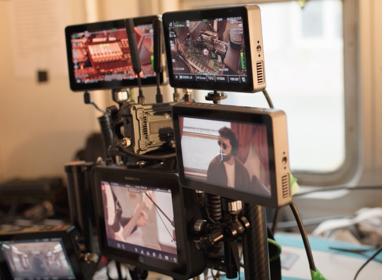 Monitor stack showing live camera feeds from the Canon cinema camera